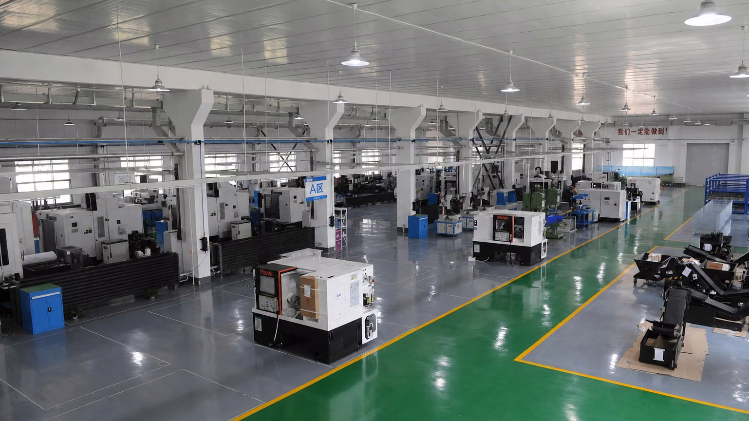 Wide CNC production workshop with organized machine rows and clear aisles